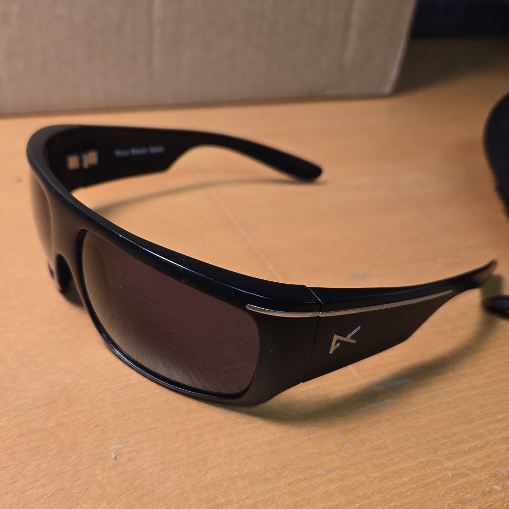 Anon Snowboard/ Surf Sunglasses with Sleek Design and Dark Tint.
